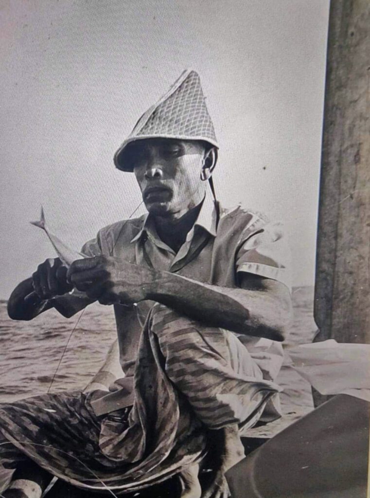 Fisherman hooking a bait fish