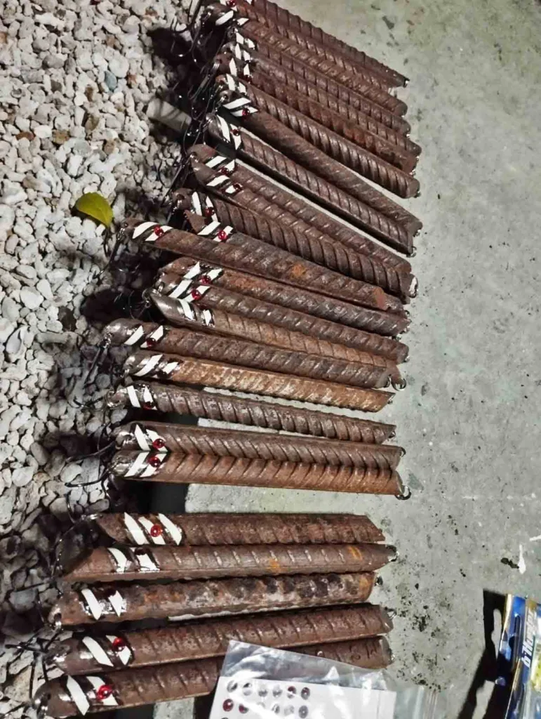 Cut iron rebar bars decorated with reflective stickers and red eye accents used as cheap fishing lures for Kattelhi in Fuvahmulah.