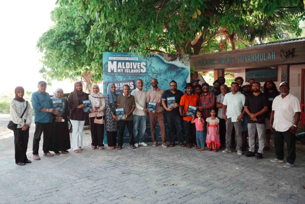 Guests and participants pose with the inaugural edition of Maldives My Islands magazine at Pelagic Divers Fuvahmulah