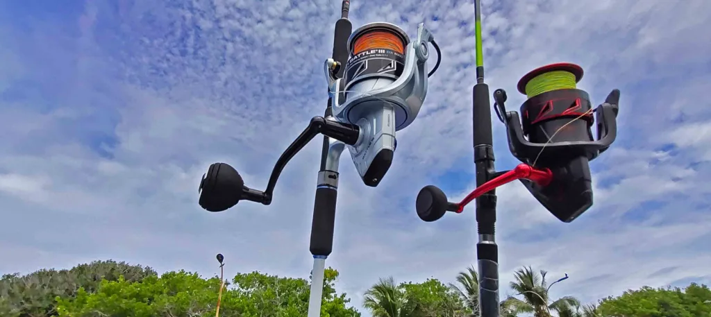 Modern heavy-duty spinning reels and fishing rods mounted on a launch against a clear blue sky in Fuvahmulah.